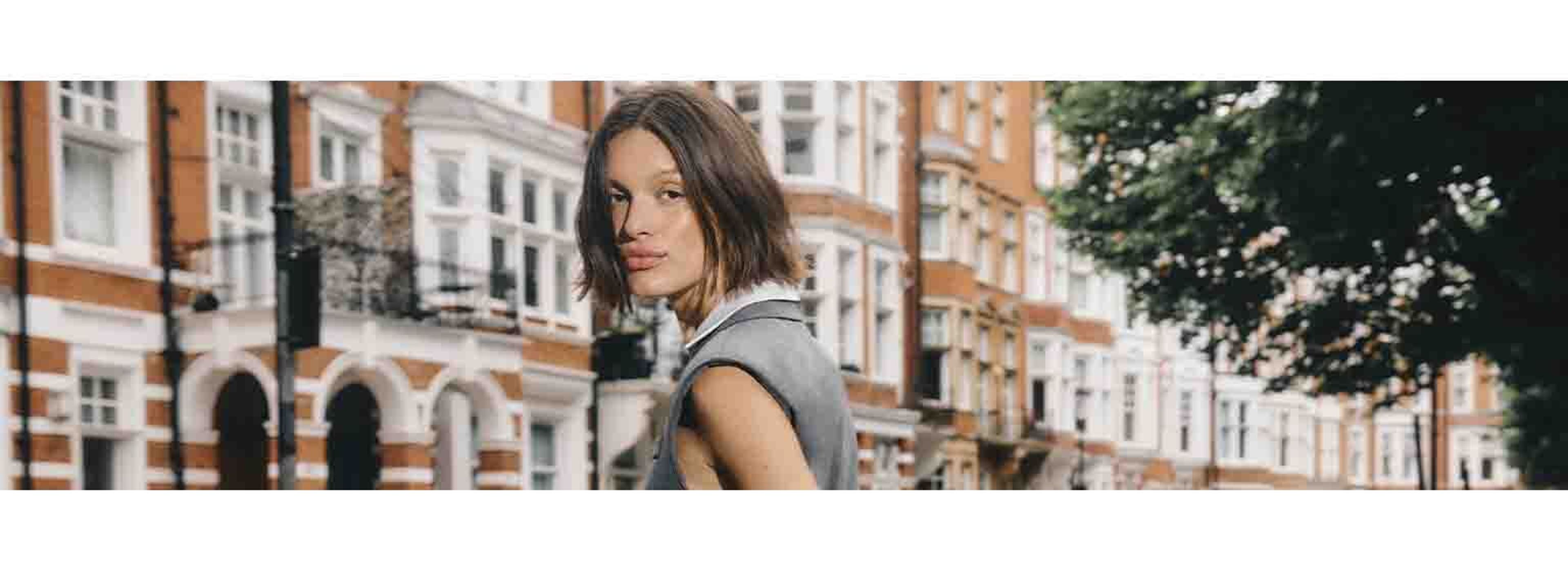woman in grey outfit posing in london streets