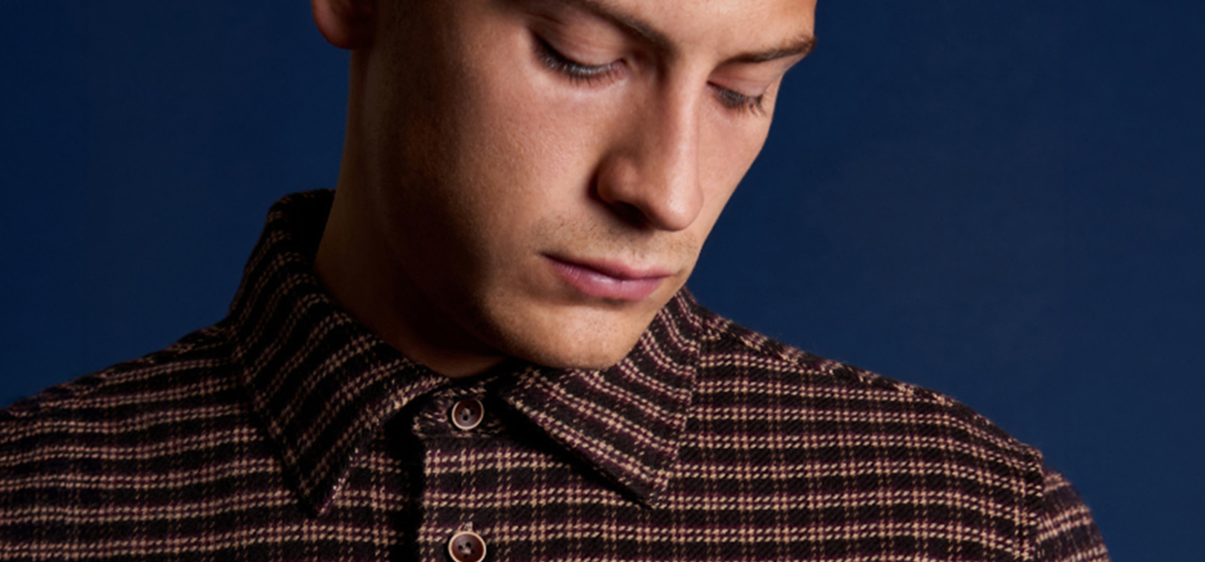 man looking down at his pocket