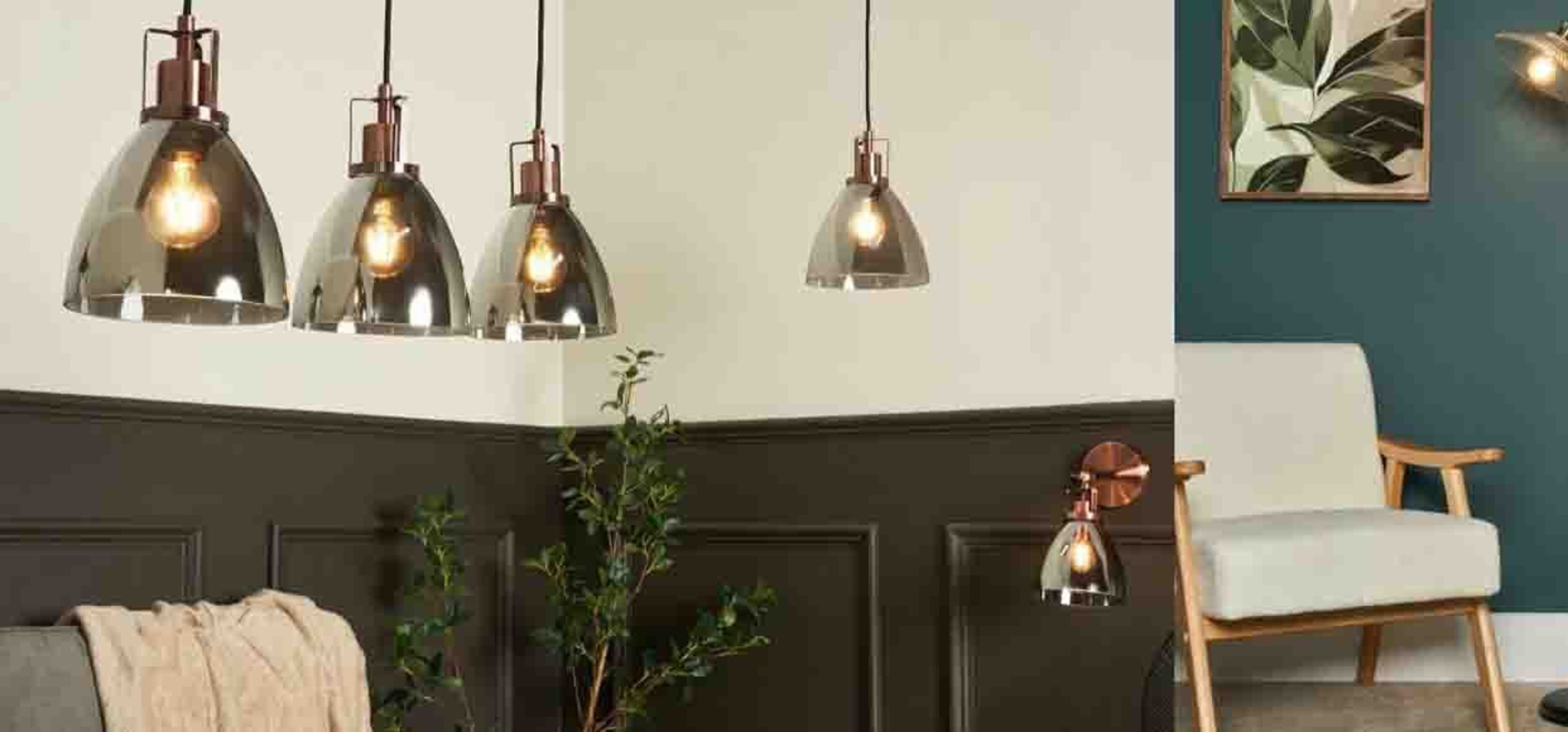 a close up shot of hanging lamps and a chair