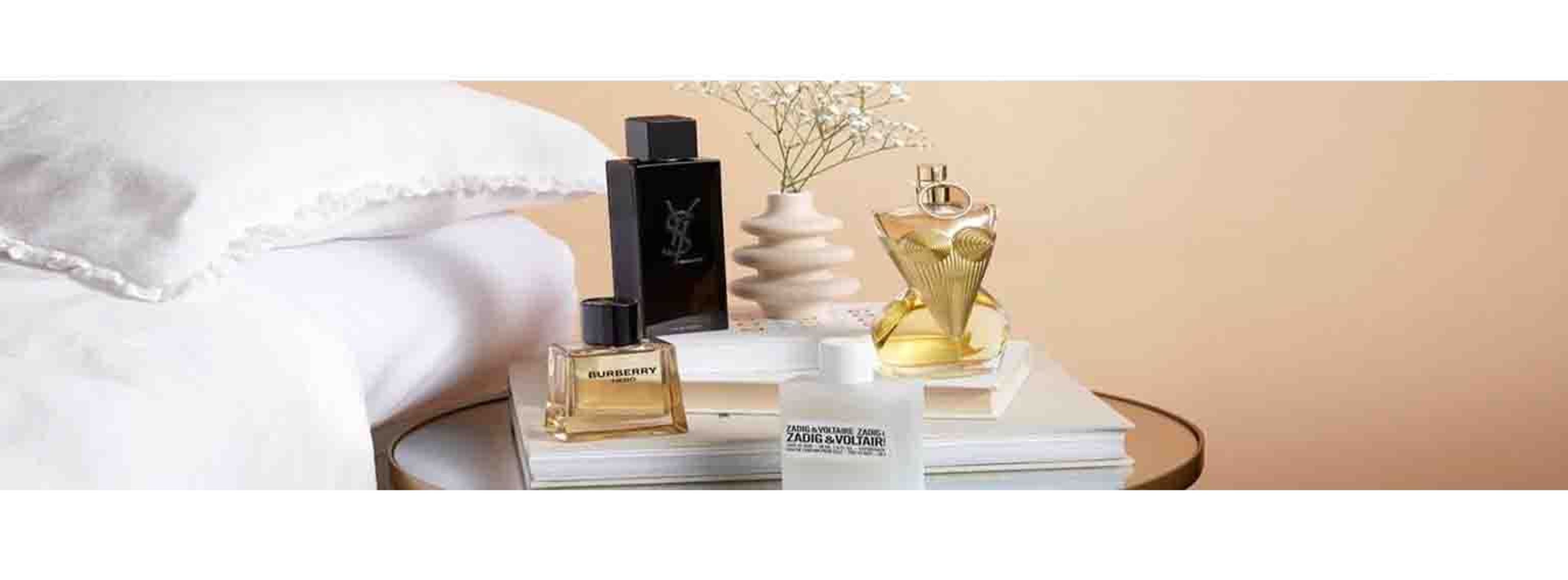 image of perfumes on a bed side table