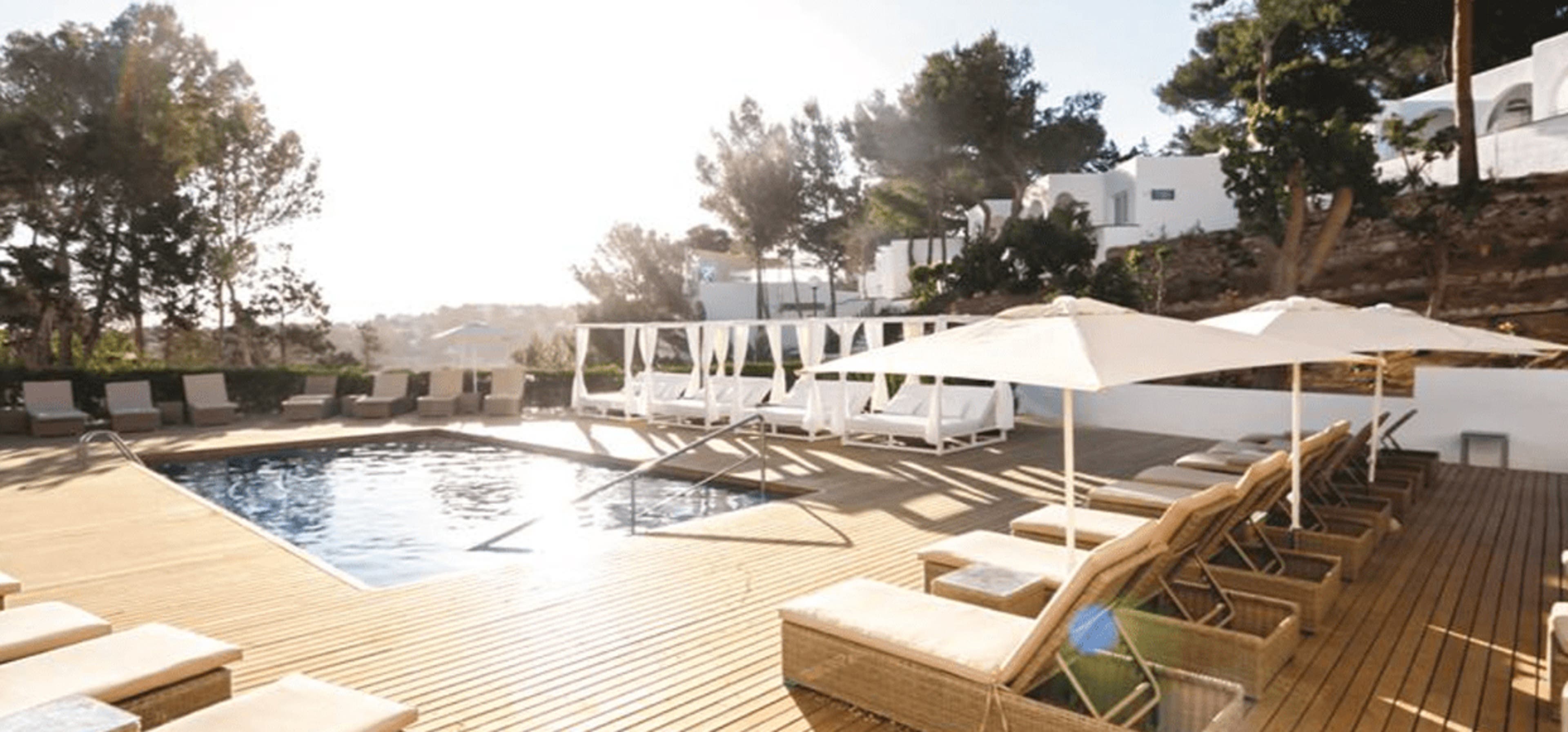 A picture of a villa with the pool view and the pool chairs