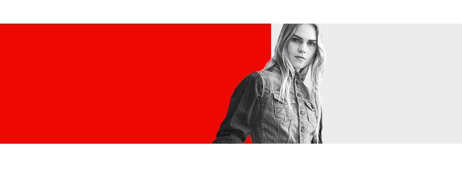  Model posing in denim in front of an abstract background of red and white 