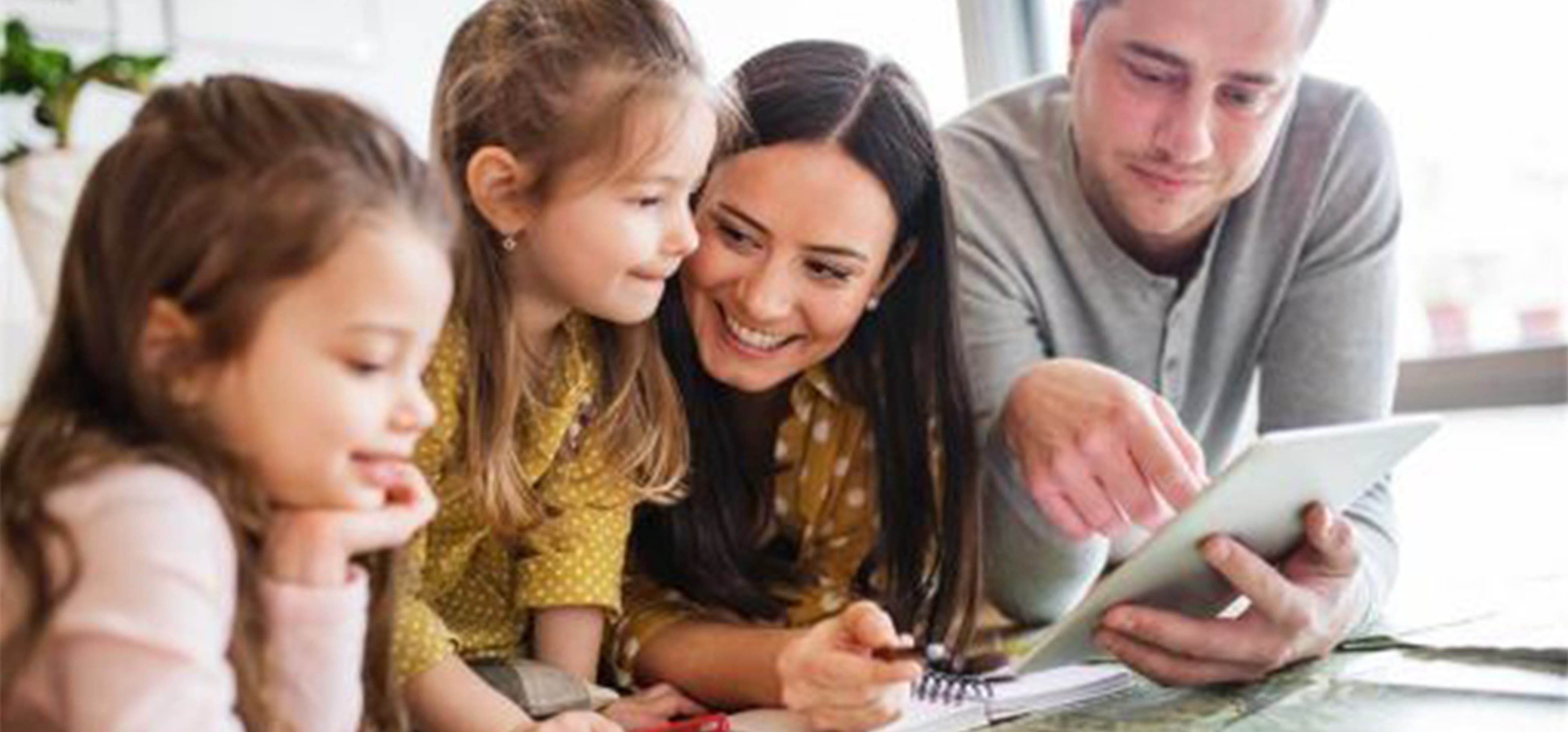 family sat together choosing holiday