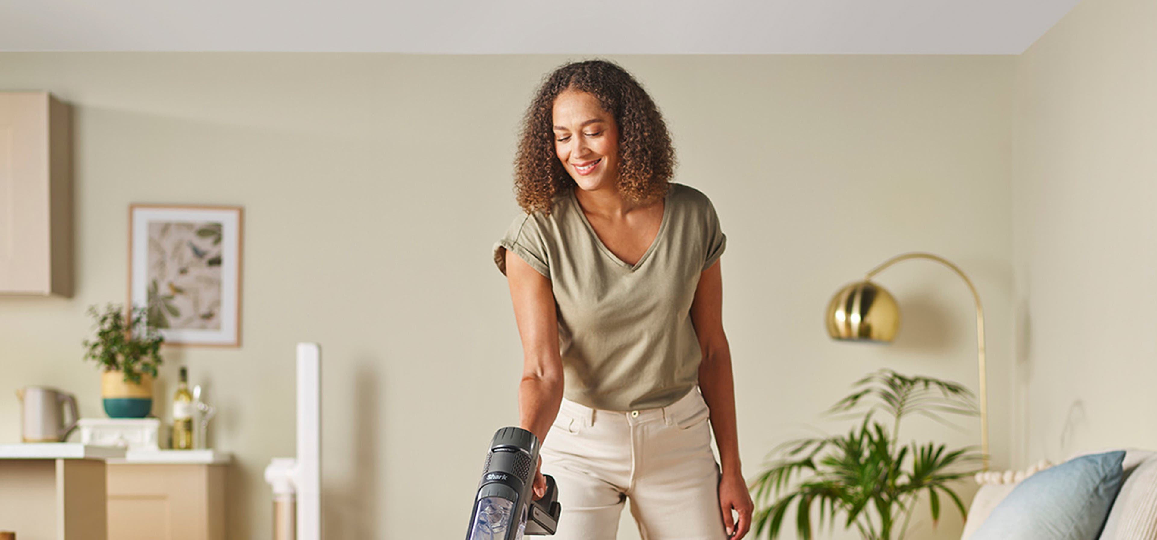 woman hoovering in living room