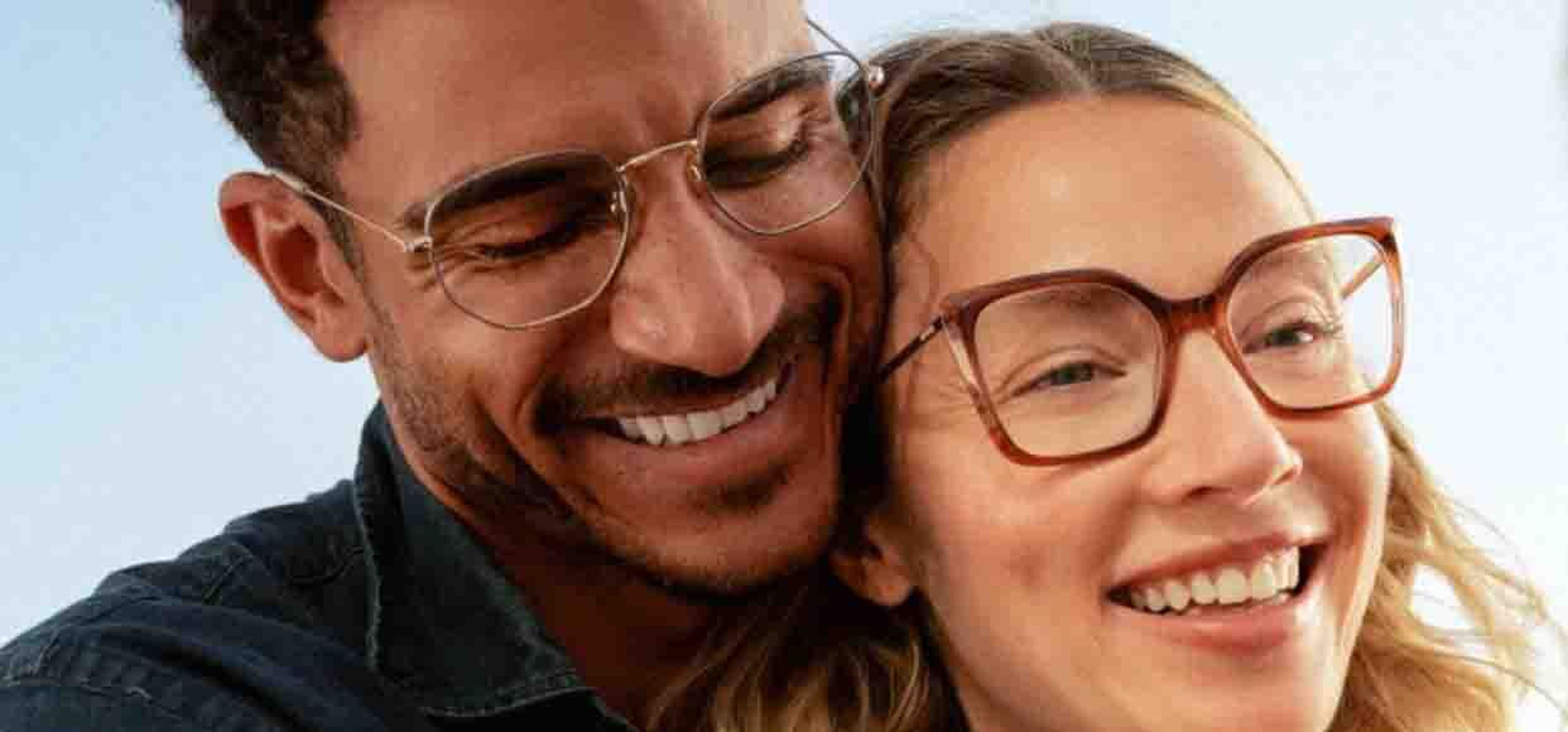 two couples smiling happily wearing glasses